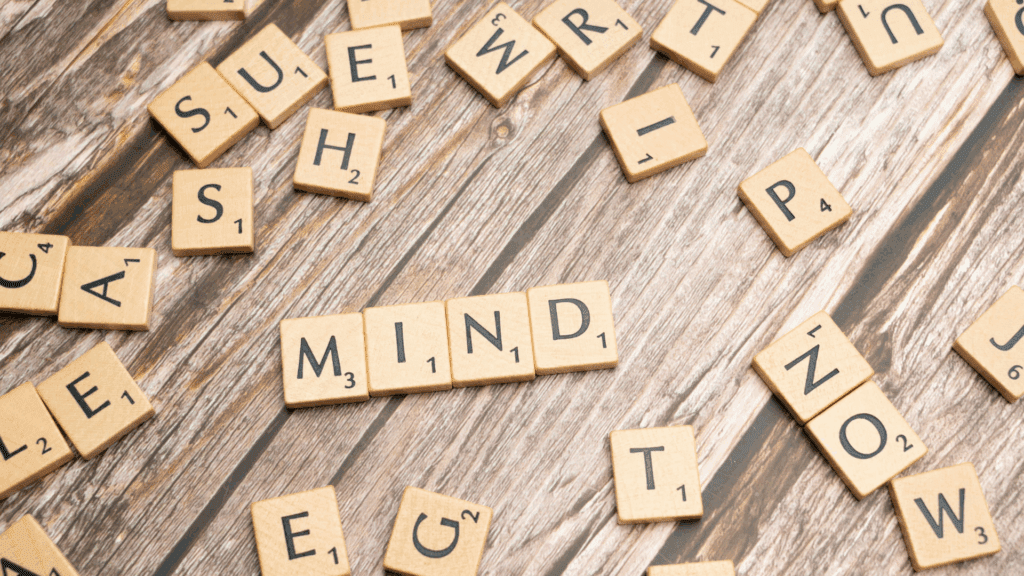 Life Coaching vs Neuroscience Coaching: A Complete Guide 9 Mind spelled in scrabble tiles illustrating cognitive approach in life coaching vs neuroscience coaching