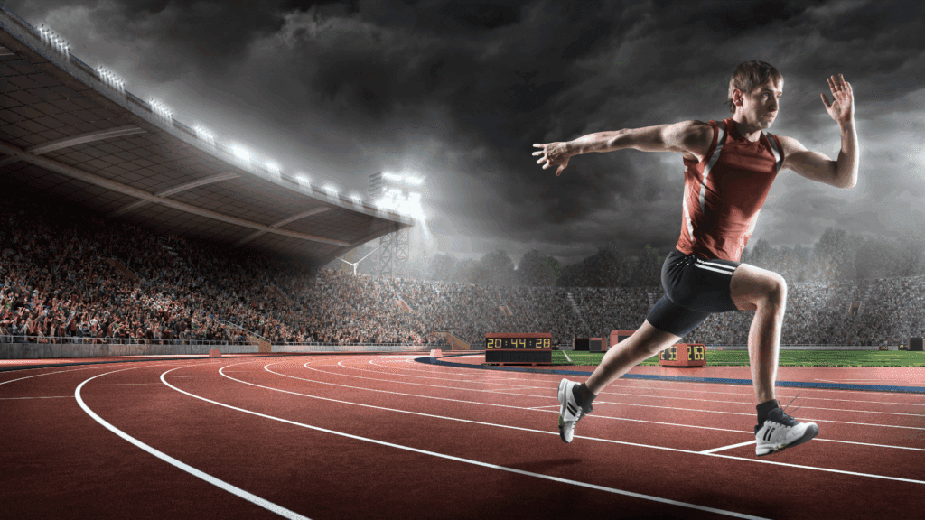 Track athlete sprinting focused on peak performance through neuroscience of performance coaching methods.