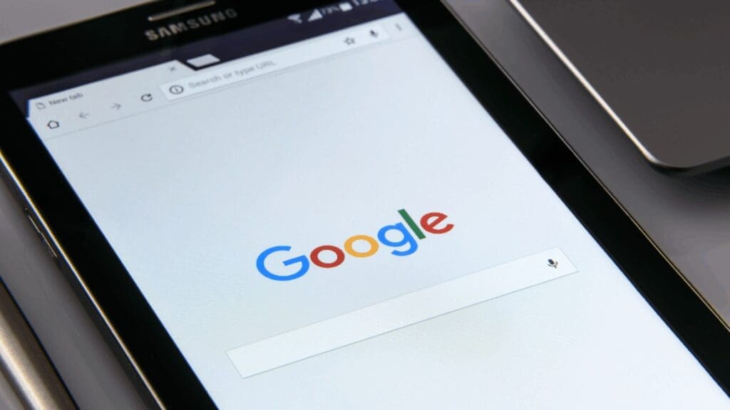 A tablet displaying the Google homepage, representing search visibility for topical authority in neuroscience-based coaching.