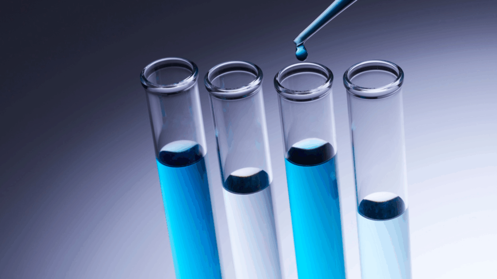 Laboratory test tubes with blue fluid, representing scientific study of the neuroscience-based approach to emotional stability, dopamine and mood swings.