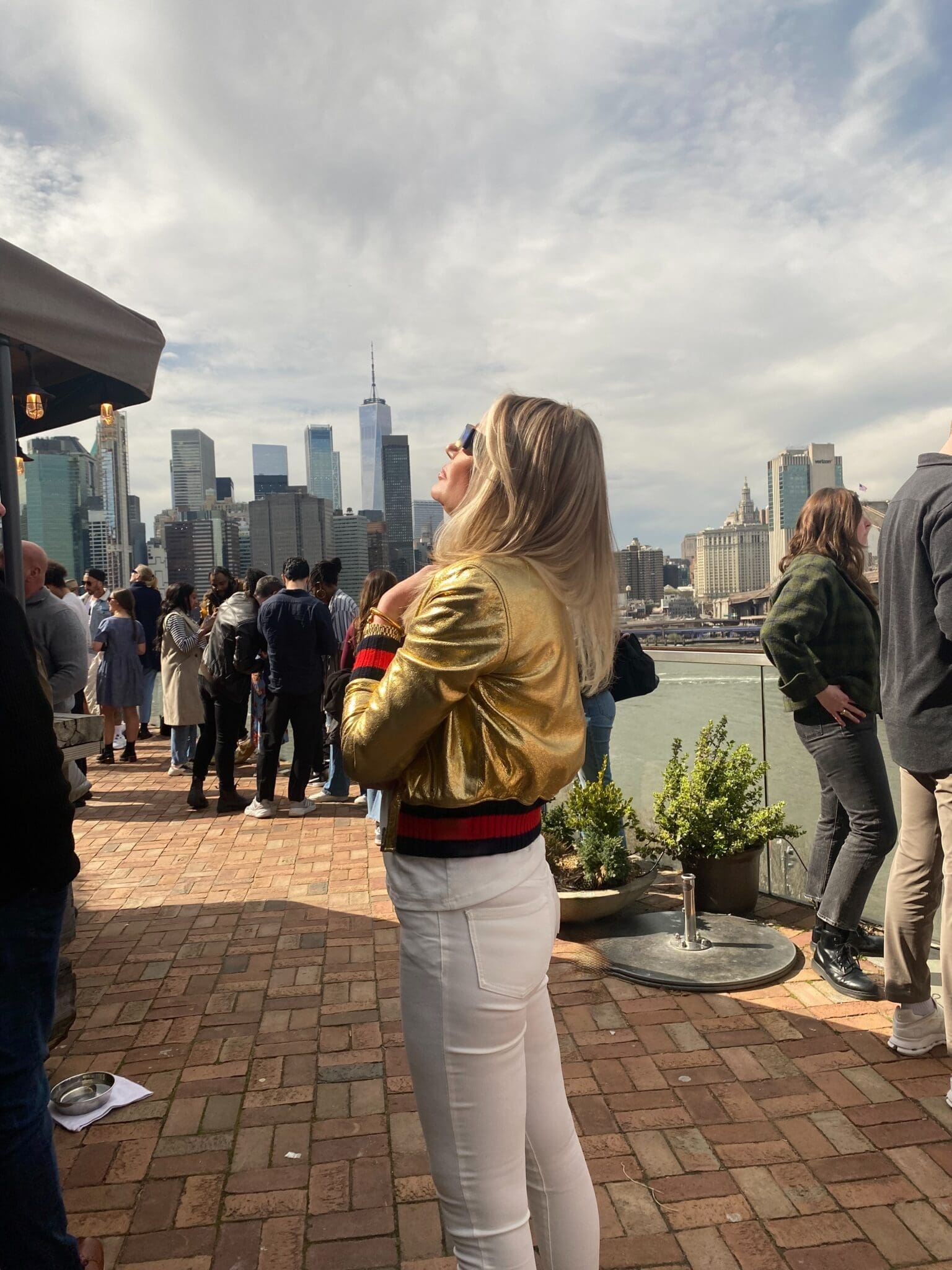 Dr. Sydney Ceruto 34 Dr. Sydney Ceruto in gold jacket looking at Freedom Tower NYC showing confidence and high-achiever mindset
