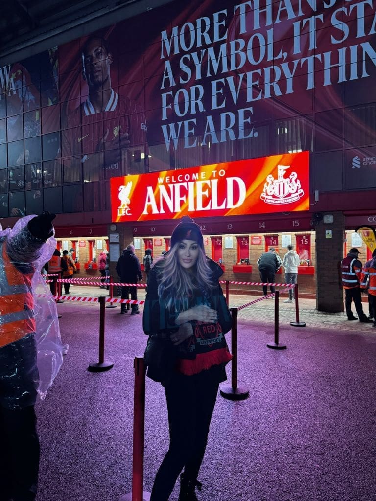 Dr. Sydney Ceruto 57 Dr. Sydney Ceruto posing in front of the Welcome to Anfield sign at Liverpool Football Club stadium on match day