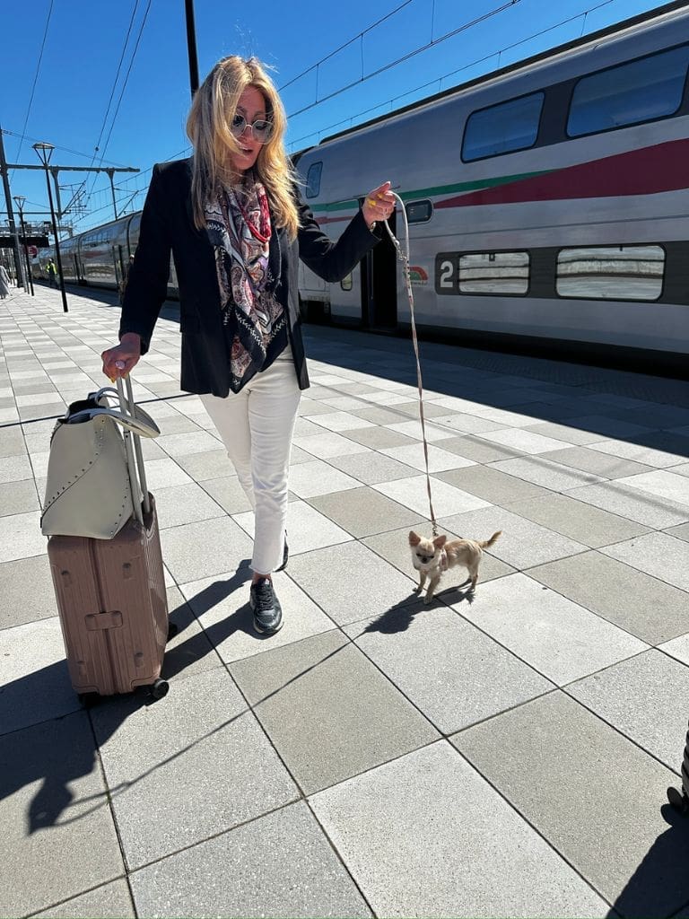 Dr. Sydney Ceruto 55 Dr. Sydney Ceruto, MindLAB Neuroscience neuro-advisor, walking along a Moroccan train platform with her dog and luggage in Casablanca