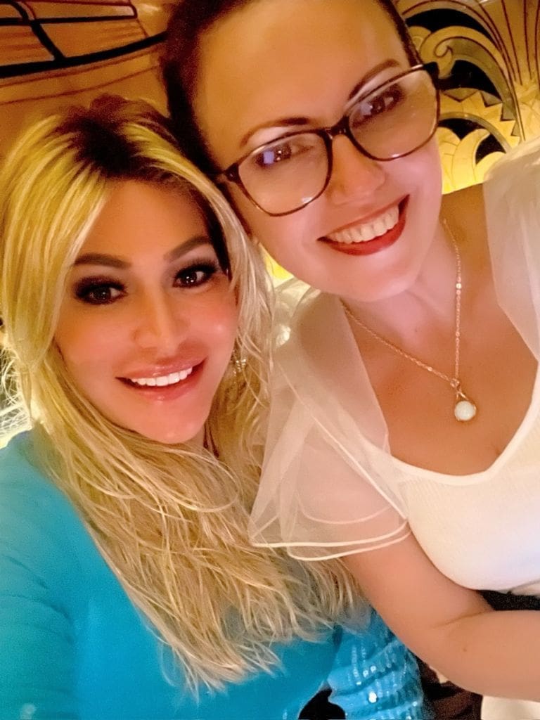 Dr. Sydney Ceruto 50 Dr. Sydney Ceruto smiling warmly in a selfie with a close friend during an evening dinner out